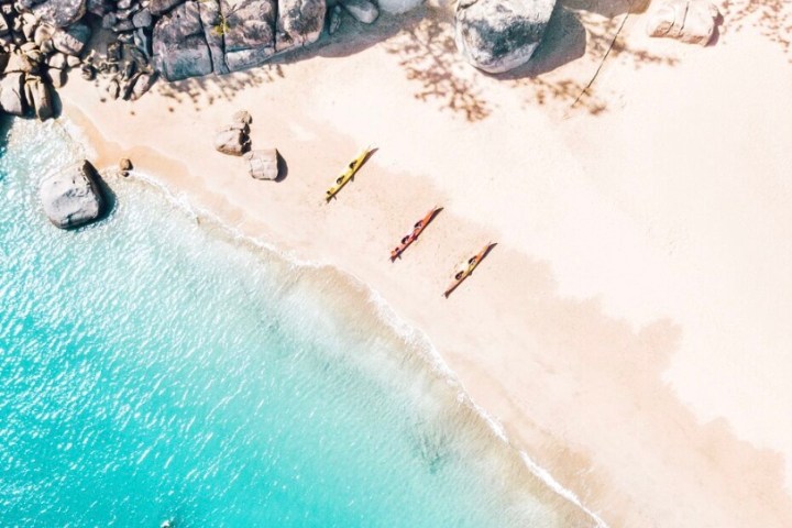 birds eye view of 3 kayaks on the beach