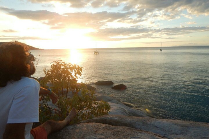 man watching sunset from shore